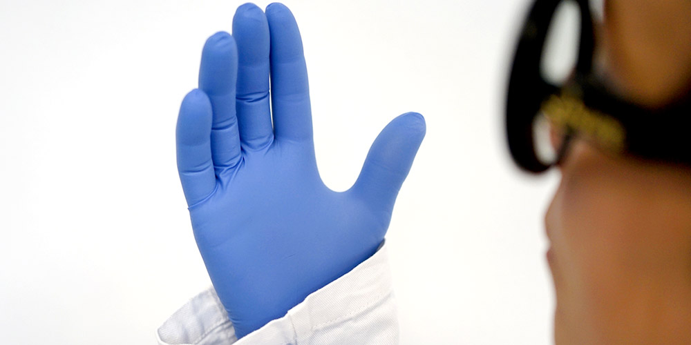 Checking gloves for damage before use