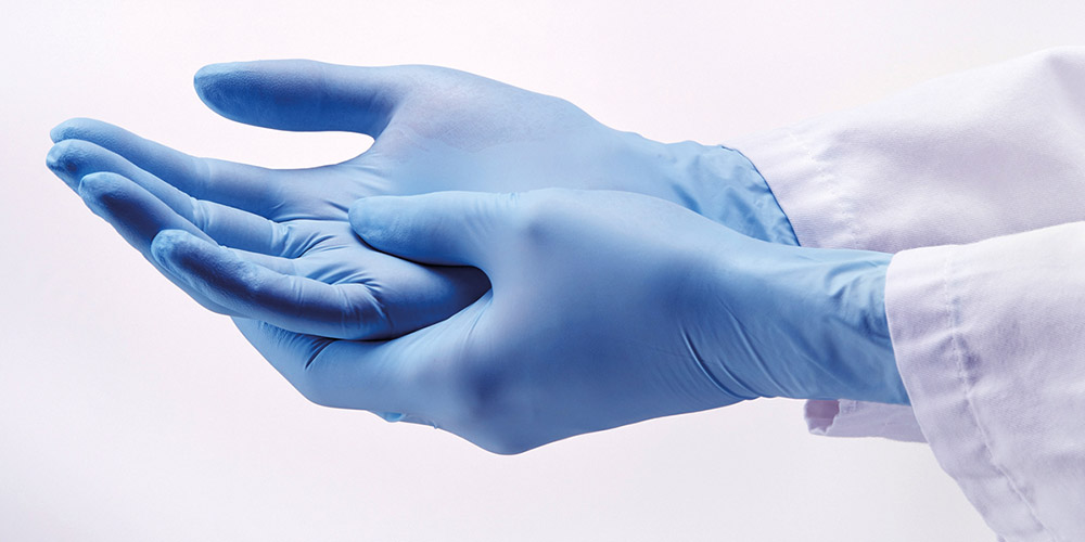 Hands wearing laboratory gloves